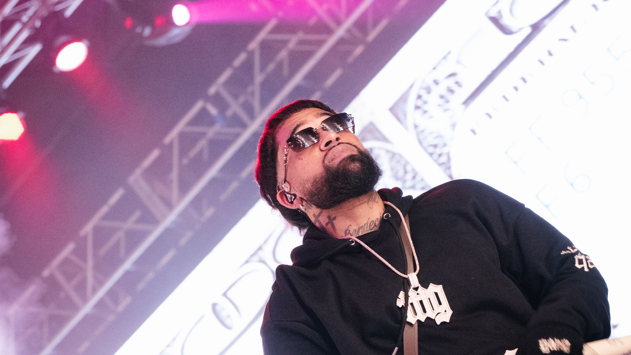 Bryant Myers on stage in the black % hoodie